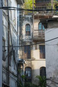 an old building with windows on the side of it at Bellimena Stone Town in Zanzibar City +5 photos