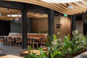 a restaurant with tables and chairs in a room at Apartman Emily B311 in Veselé