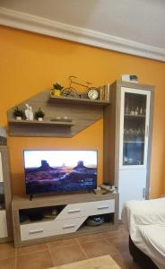 a living room with a flat screen tv on a wall at Naturaleza y Golf in San Jorge
