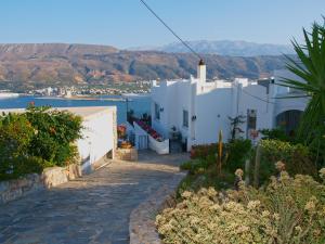 a street in a village with white buildings at Panoramic Seaview Holiday House in Souda