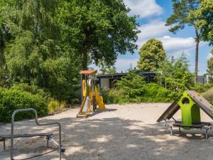 a playground with play equipment in a park at Vakantiepark Ackersate in Voorthuizen
