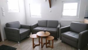 a living room with two couches and a table at Backspieker BACK in Sögel