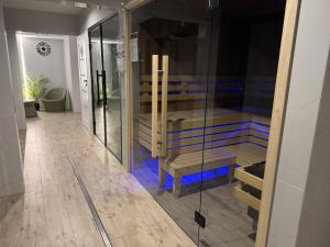 a room with a walk in closet with a glass wall at Hotel Vestina in Wisła