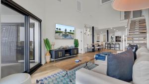 a living room with a white couch and a table at 516 Seascape Oceanfront Condo with Pool Access in Wild Dunes in Isle of Palms