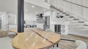 a kitchen and dining room with a wooden table at 516 Seascape Oceanfront Condo with Pool Access in Wild Dunes in Isle of Palms