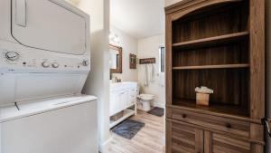 a bathroom with a sink and a white refrigerator at Geraldine Drive by AvantStay Hot Tub Views Walk to Trails Game Room in Incline Village +30 photos