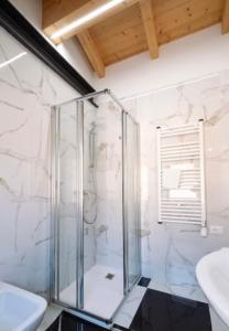 a glass shower in a bathroom with a sink at Welc-ōM Celeste Rooms in Ponte di Brenta