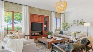 a living room with couches and a tv at Wine Country Escape w Views Wine Cellar Gym Caterina Dusi Vineyard by AvantStay in Paso Robles