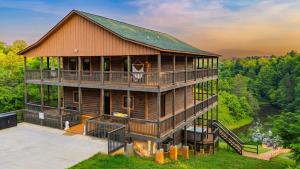 an aerial view of a house with a wrap around deck at Lions Landing by AvantStay Sleeps 18 Hot Tub Game Room Views Near Pigeon Forge in Sevierville