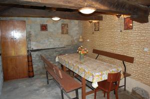 a dining room with a table and chairs with flowers on it at Holiday Home Lyubovo in Gabrovo