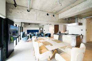 a kitchen and dining room with a table and chairs at Modern Palazzo住吉 in Fukuoka