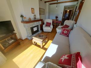 a living room with a couch and a fireplace at C19 - Bellavista Pirineo - Villmor in Cerler