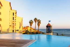 a swimming pool with a view of the ocean at Britania Luxury - With a sea view in Parede