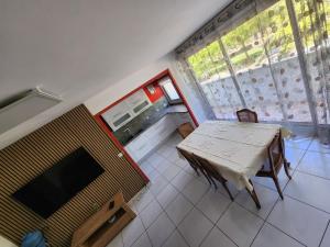 a small room with a table and a television at Chambre privée in Le Mée-sur-Seine