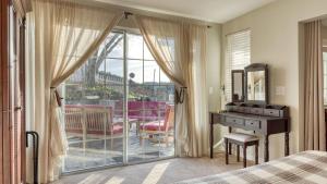 a bedroom with a bed and a desk and a window at Luxury Wine Country Haven Vineyard Views Near Top Wineries Adelaida Farmhouse in Paso Robles