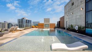 a swimming pool on the roof of a building at 2 Condos in New Austin High Rise Luxe Amenities Rooftop Pool GymYoga Studio in Austin
