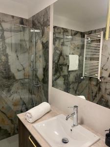 a bathroom with a sink and a shower at CozyNestApartament in Lublin +11 photos