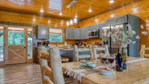 a kitchen with a table and a dining room at Indoor Pool Theater Hot Tub Mountain Views Near Dollywood Crimson Crest by AvantStay in Line Spring