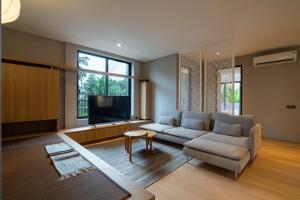 un soggiorno con un divano e una TV di Umahan Ubud ad Ubud