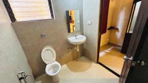 a bathroom with a toilet and a sink at Claudina baga beach in Calangute