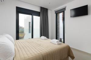 a bedroom with a bed with two towels on it at Davlakos Apartments Rea in Kremasti