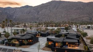 an aerial view of a resort with mountains in the background at Blackhaus D: 4 Bedroom Suite by AvantStay 4-Room Retreat in Palm Springs