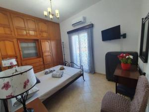 a living room with a bed and a table and chairs at Lenio's Home in Pera Gyalos