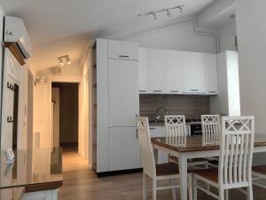 a kitchen and dining room with a table and chairs at Penthouse sky view in Iaşi +5 photos