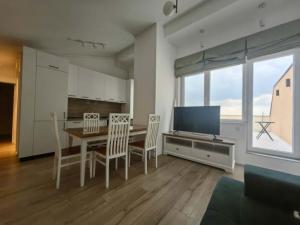a kitchen and dining room with a table and chairs at Penthouse sky view in Iaşi