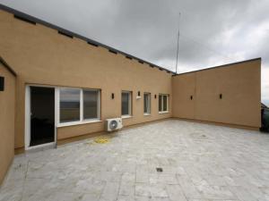 a building with a large patio with a tv on it at Penthouse sky view in Iaşi