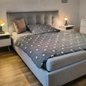 a bedroom with a large bed with two lamps at Apartment Amsterdam - Berlin in Lügde