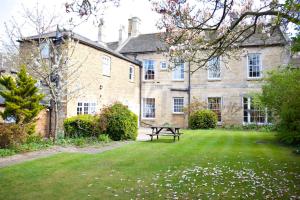 a large stone building with a picnic table in the yard at Garden House Stamford in Stamford