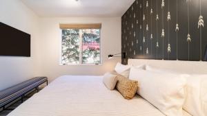 a bedroom with a bed and a tv on the wall at Aspen Hideaway by AvantStay Walk to Aspen Near Slopes Pool Hot Tub Access in Aspen +18 photos