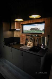 a kitchen with a counter and a sink and a window at Gjeterhytta in Stavanger