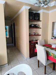 a kitchen and dining room with a table and chairs at Condomínio Royal Park - bairro Coqueiro in Ananindeua