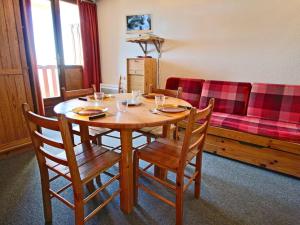 a dining room table with chairs and a couch at Studio cabine cosy, 4 pers, balcon sud, au pied des pistes – Chamrousse 1750 - FR-1-340-106 in Chamrousse