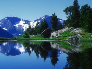 a reflection of a mountain in a lake with trees at Studio 3 places au pied des pistes avec balcon et animaux acceptés - Chamrousse 1750 - FR-1-340-175 in Chamrousse
