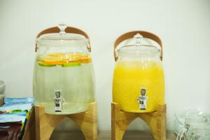 two glass jars filled with drinks on wooden stands at Garni Hotel Krško in Leskovec pri Krškem