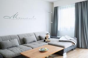 a living room with a couch and a table at Lechsee Lodge - Haus Bergliebe Nr 4 in Lechbruck