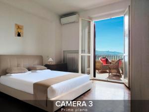 a bedroom with a bed and a balcony with a view at Villa Gelsi a Pesaro in Pozzo Alto +35 photos