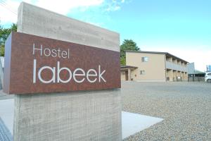 a sign for a hospital labeledelbeck in front of a building at Hostel labeek in Fujikawaguchiko