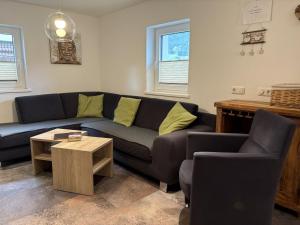 a living room with a couch and a table at Holiday Home Machreich by Interhome in Bruck an der Großglocknerstraße +40 photos
