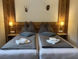a bedroom with a bed with two pillows on it at Holiday Home Machreich by Interhome in Bruck an der Großglocknerstraße