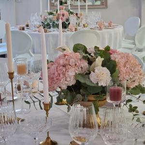 a table with a centerpiece of pink flowers and candles at Chambres d'hôtes de montcausson in Revel +49 photos