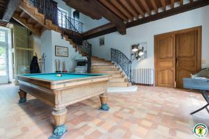 a room with a pool table and a staircase at Chambres d'hôtes de montcausson in Revel