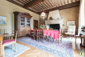 a dining room with a table and chairs and a fireplace at Chambres d'hôtes de montcausson in Revel
