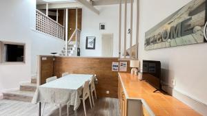 a dining room with a table and chairs at Villa Liberté in Villejuif
