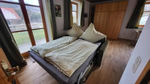 un lit assis dans une pièce avec une fenêtre dans l'établissement Ferienwohnung Osser Woid, à Lohberg 28 autres photos
