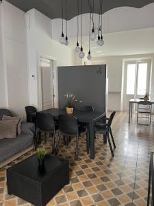 a living room with a black table and chairs at Hostal Sant Marti in Puigreig