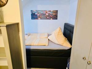 a bed with two pillows on it in a room at Apartment Altstadt 50m vom Bodensee in Meersburg